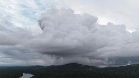 Massive Rain Cloud Over Jungle. Stock Photos