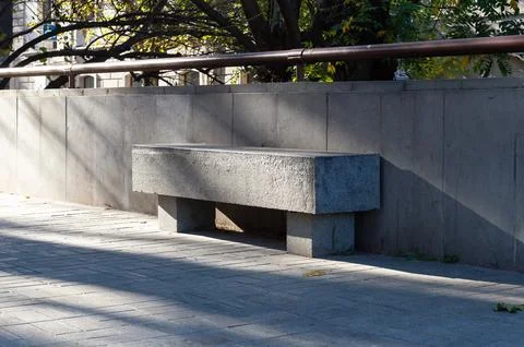 Massive rectangular shape stone bench standing in the street Stock Photos