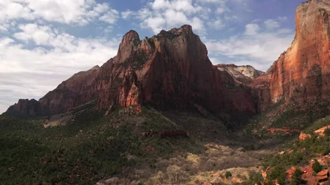 Massive Red Rock Mountain with Green Forest Stock Footage 317330832