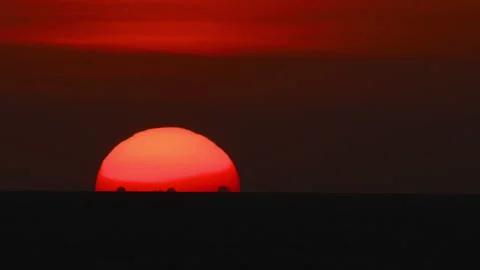 Massive red sun setting over sea Stock Footage 321425885
