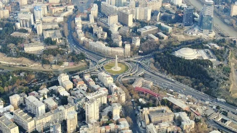 Massive road junction full of traffic in the middle of Tbilisi, 4k aerial Stock Footage 105647117