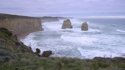 Massive rock formations stand along Great Ocean Road Stock Footage 83870663