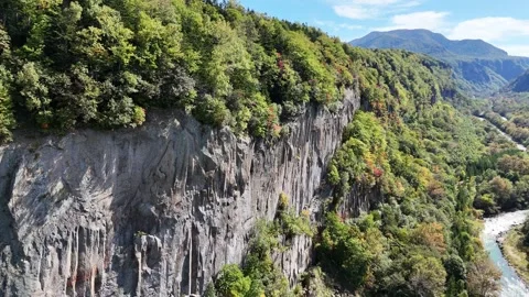 Massive Rock Wall | Columnar Joints | Autumn Valley | Cliff - 4K Aerial Video Stock Footage 329046415