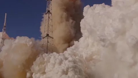 A massive rocket engine ignites at the launchpad creating thick clouds of smoke Stock Footage 334043038