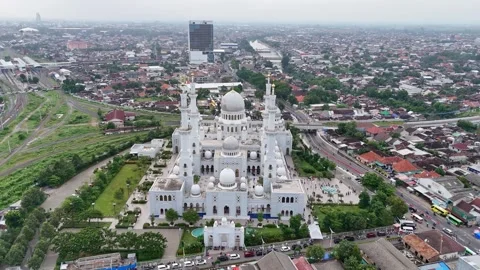 Massive Sheikh Zayed Grand mosque surrounded by cityscape, aerial orbit view Stock Footage 303795425