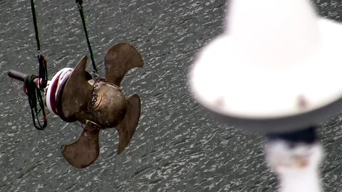 Massive ship propeller being lowered into water via crane Stock Footage 123726170