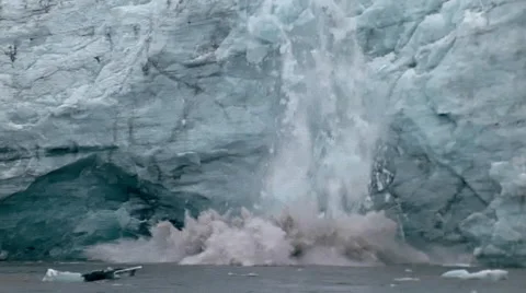 Massive slab of ice falls from the face of a glacier. Stock Footage 67616021