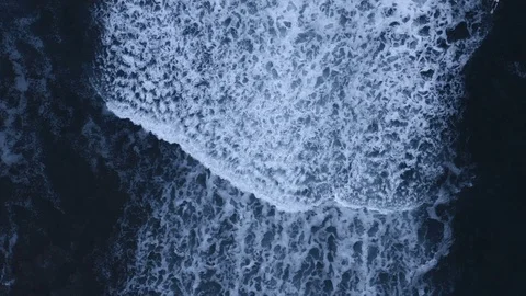 Massive slow-motion wave crashes to shore, top down view Stock Footage 112702913