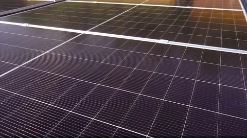 Massive solar panel farm and greenhouses for tomatoes, aerial top down view Stock Footage 347618247