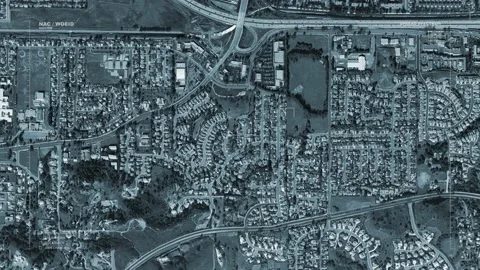 A massive spaceship passes over a freeway interchange. With HUD Stock Footage 133680501