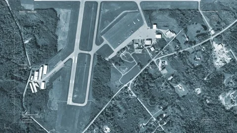 A massive spaceship passes over a small, regional airport. With HUD Video stock 133680455