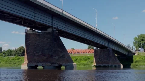 Massive stone support piers of Vienibas Unity bridge over Daugava river in Stock Footage 340892531