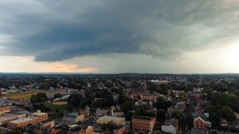 Massive storm clouds approach urban city landscape, rain and danger on the Stock Footage