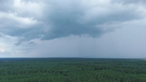Massive storm clouds with pouring rainfall above woodland, aerial view Vídeo Stock 315218126