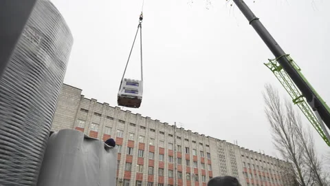 Massive structure ascends slowly suspended by thick straps Stock Footage 311622405