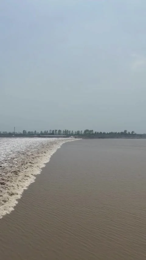 Massive Tidal Bore Wave Rolls Along Qiantang River, Hangzhou, Zhejiang, China Stock Footage 337385427