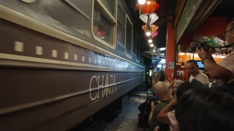Massive Train Passing Close to Tourists at Hanoi Train Street. Stock Footage 323771560