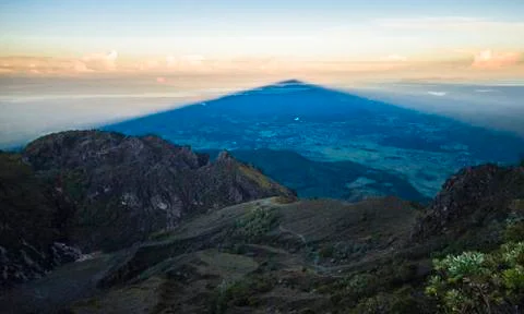 Massive triangular shadow as the sun rises over Volcan Barú, Panama Stock Photos