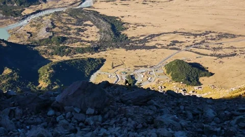 Massive valley with tiny silhouetted hikers on ridge 動画素材 310661965