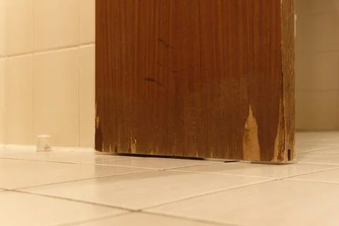 Massive water damage Moisture damage to a wooden door in the bathroom Stock Photos