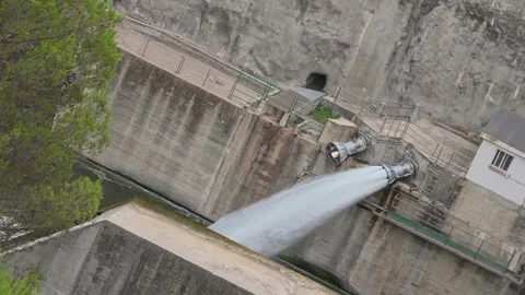 Massive water discharge from the release valve pipe of the Beniarres dam int Stock Footage 344771682