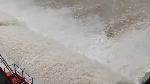 Massive water release from hydroelectric dam with heavy current Stock Footage 315569112