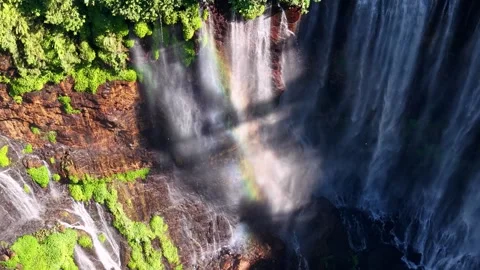 Massive waterfall cascades down rugged cliff face Stockbeeldmateriaal 346252309