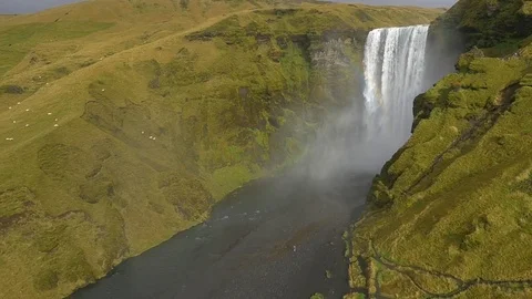 Massive waterfall gushing through the green mountains Stock Footage 74906163