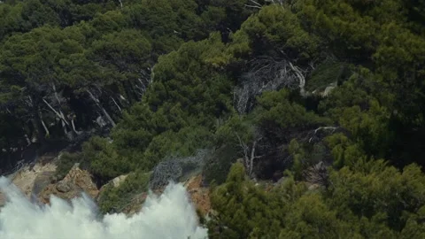 Massive wave hitting forest on small Mediterranean island Stock Footage 168774864