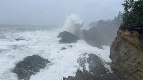 Massive wave splashes on Oregon Coast at Shore Acres on stormy day Stock Footage 329448759