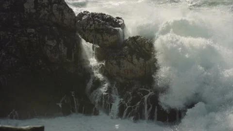Massive waves covering rock formations on coast Video stock 168775158