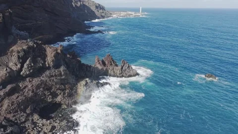 Massive waves crash against volcanic cliffs, La Palma shoreline highlighting Stock Footage 308399740