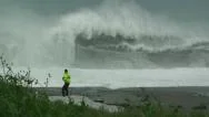 Massive Waves Crash Onto Beach Dangerously Near Man Stock Footage