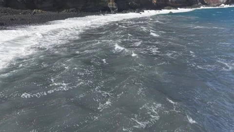Massive waves crashing onto dark volcanic shore, highlighting Canary Islands Stock Footage 308396838