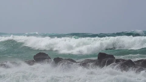 Massive waves over wavebreaker, slow motion Stock Footage 183987805