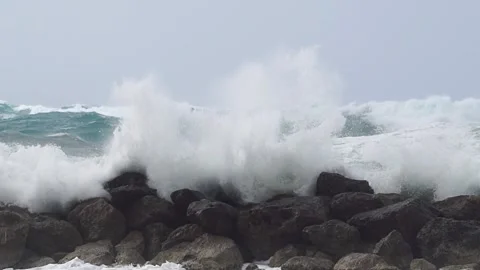 Massive waves spash over wavebreaker, slow motion Stock Footage 185864790