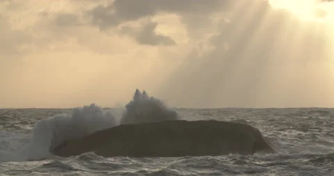Massive waves splashes over rock during storm at sunset Stock Footage 133205376