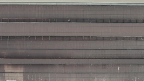 A massive weathered corrugated metal facade of an old steel factory in Hungary Stock Footage 337100870
