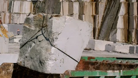 Massive white marble block loading into dump truck, suspended by heavy Stock Footage 309219400