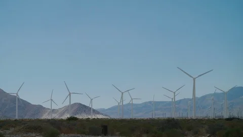 Massive wind turbines spin on windy day at the San Gorgonio Pass WindFarm Stock Footage 113301455