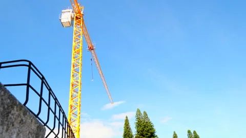 Massive yellow construction crane at work on building site of new development Stock Footage 304308381