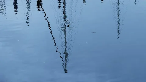 Mast reflections undulate in gentle harbor ripples Stock Footage 209935835