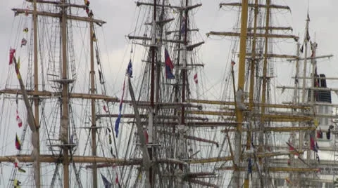 Mast sailing ship with folded sails and colored flags fluttering in the wind.  Stock Footage 26641211
