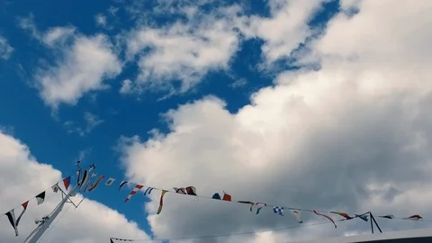 The mast of the ship with many flags of different countries against a cloudy sky Stock Footage 91821185