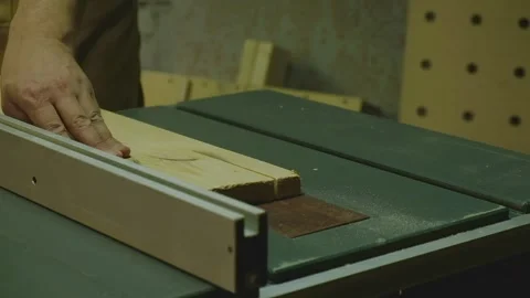 The master aligns the boards on a circular saw Stock Footage 182221189