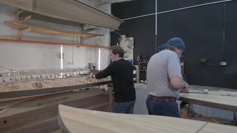 Master aligns the edge of the surf Board Stock Footage 132348387