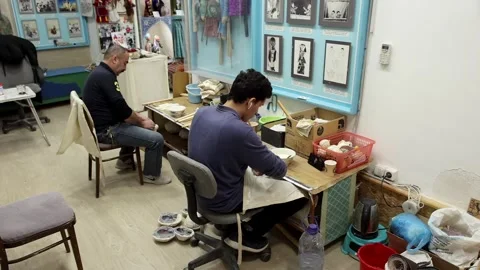 The master and his apprentice make dolls in the workshop. 스톡 동영상 247049436