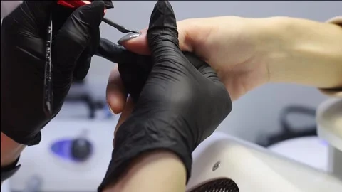 The master applies and distributes a special tool on the nail. Vídeo Stock 167404191