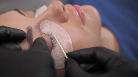 The master applies composition for lamination of eyelashes with a brush.  Stock Footage 198881666