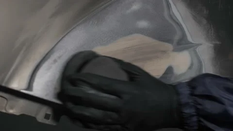  The master applies a developing coating for further grinding and painting. Stock-Footage 202169892